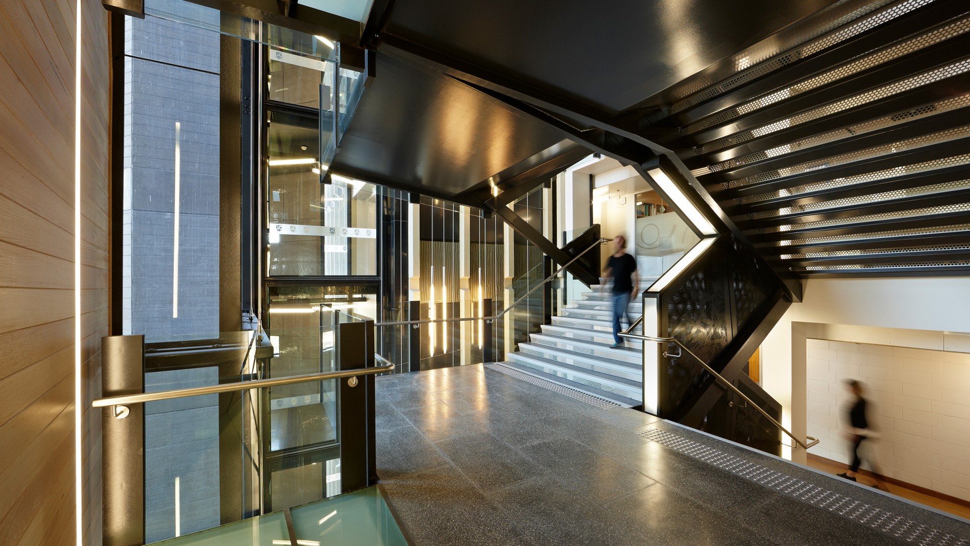 Monash University Menzies staircase, dynamic lighting, person walking down stairs