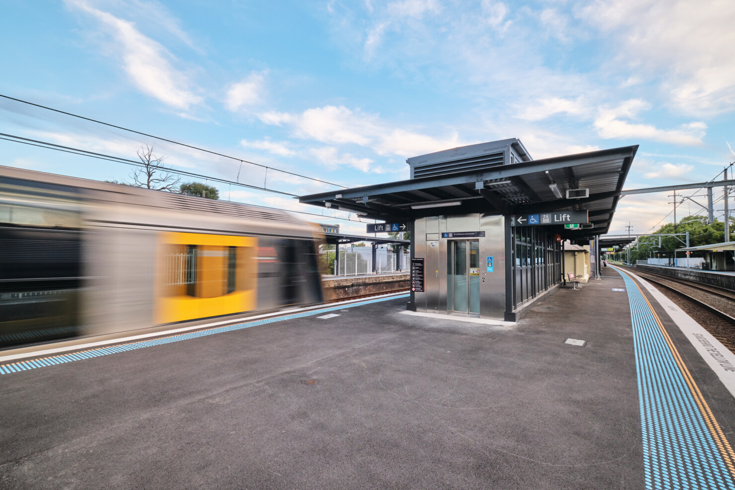 A train departs Banksia Station.