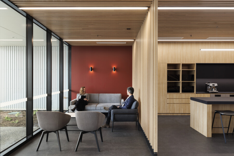 Two people sitting at a lounge area chatting with each other