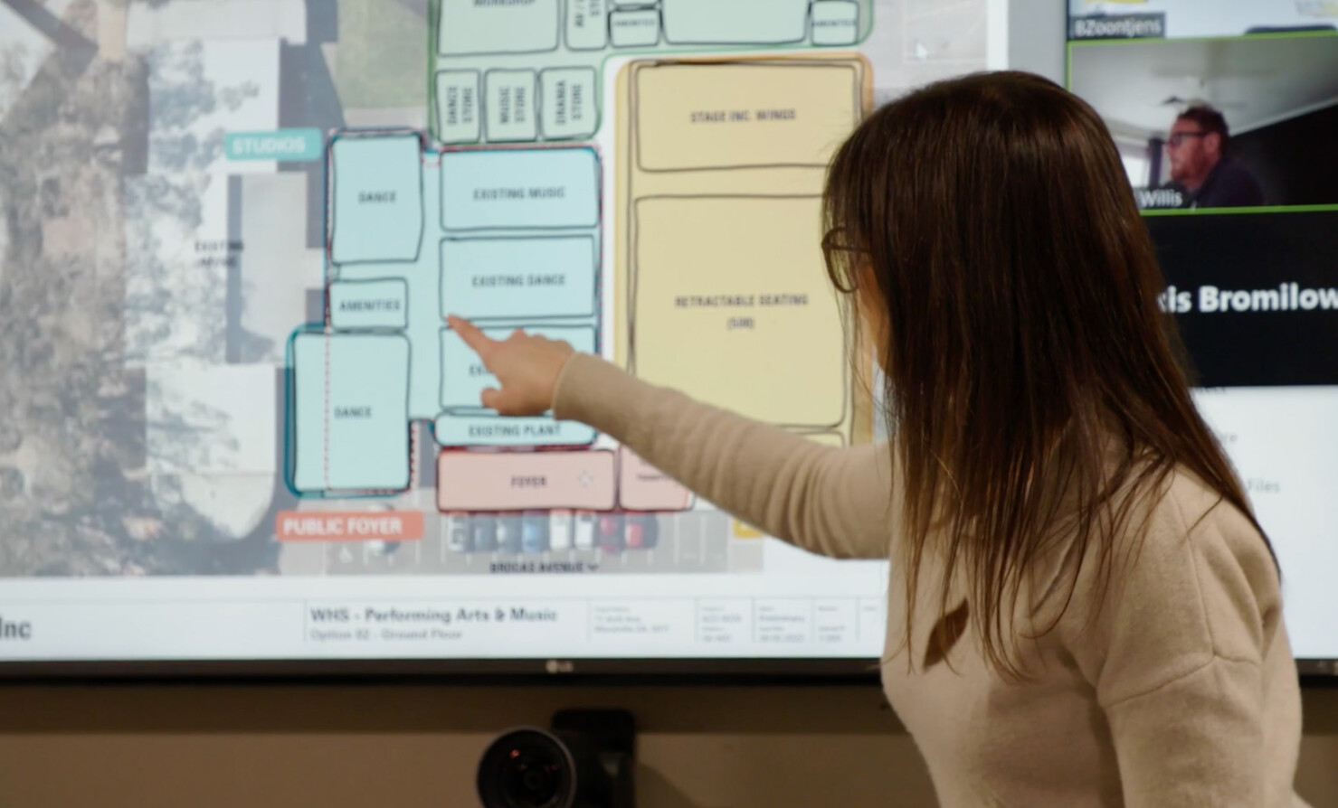 Natalie DiSisto, DesignInc Adelaide Architect points to a layout plan of a building on the screen.